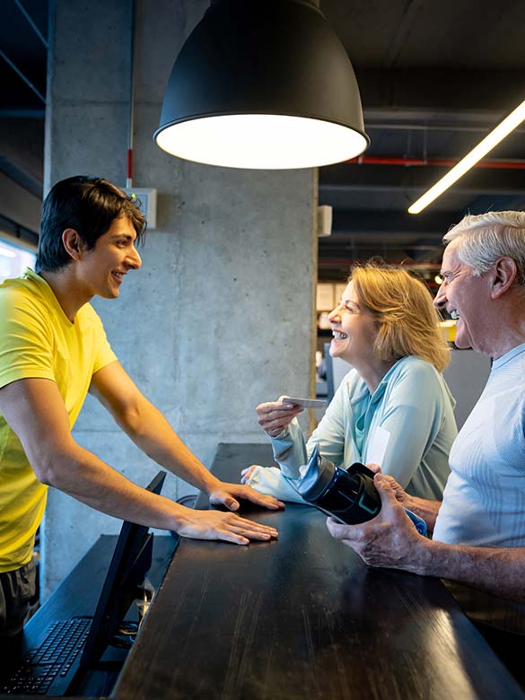 a gym trainer talking to his clients